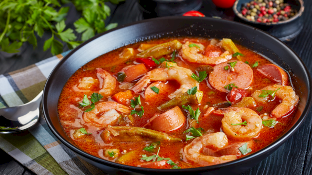 A hearty shrimp stew with sausage, tomatoes, peppers, potatoes, and herbs in a rich, tomatoy broth. Top it at 140 characters, always ending the sentence.