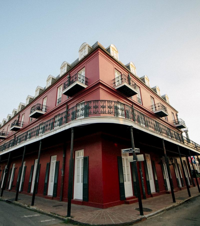 A red building with white trim and black railings
