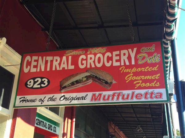 Sign for Central Grocery and Deli, highlighting imported gourmet foods and the original muffuletta sandwich, at location 923.