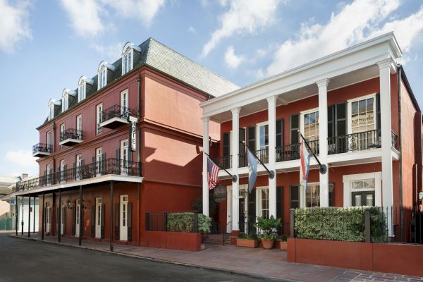 A red building with white columns and balconies